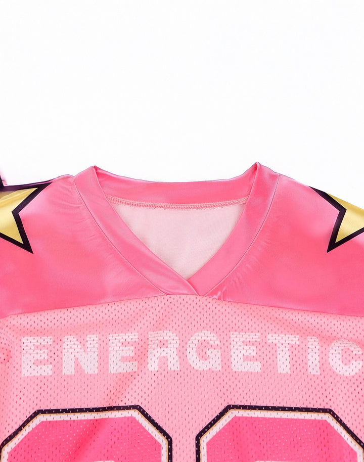 Detail shot of the V-neckline on a pink Y2K varsity-style jersey, featuring subtle printed text and a sporty mesh design for a trendy 2000s streetwear vibe.