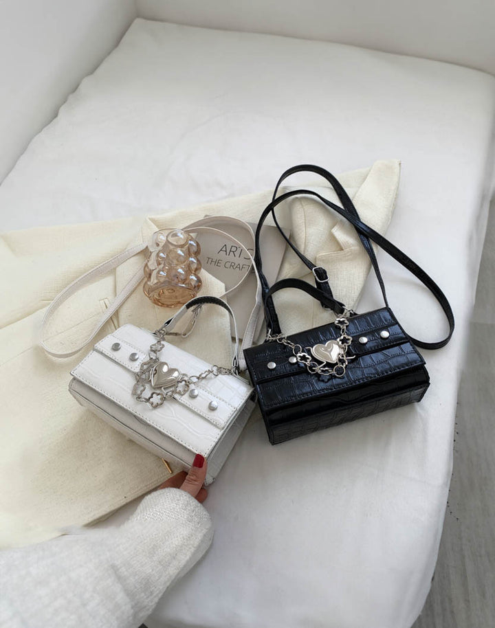 a white goth handbag with a black goth handbag