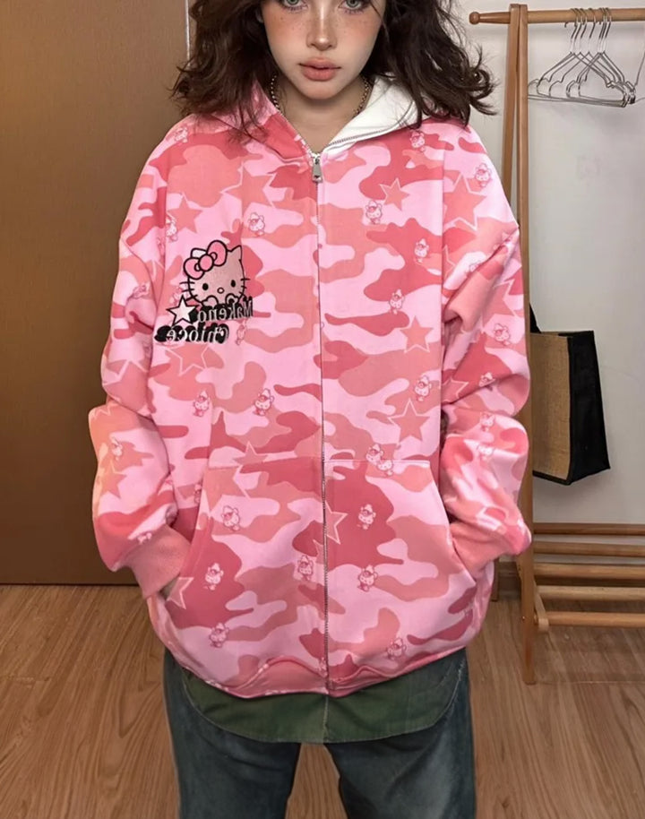Front view of model wearing Hello Kitty Camo Zipper Hoodie, displaying the full front camo pattern and graphic.