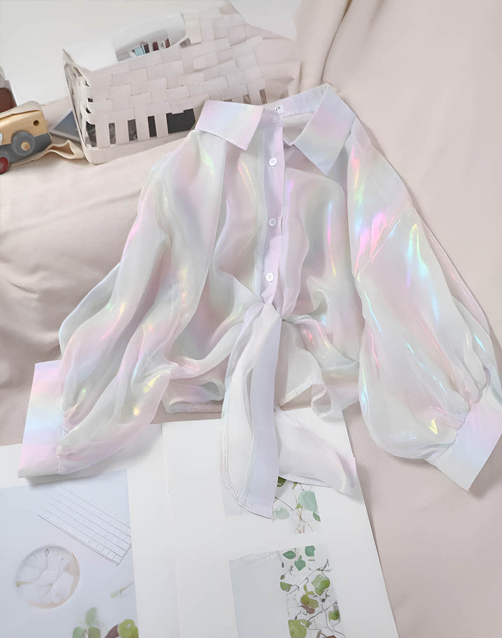 White Dazzling holographic shirt on top of sofa