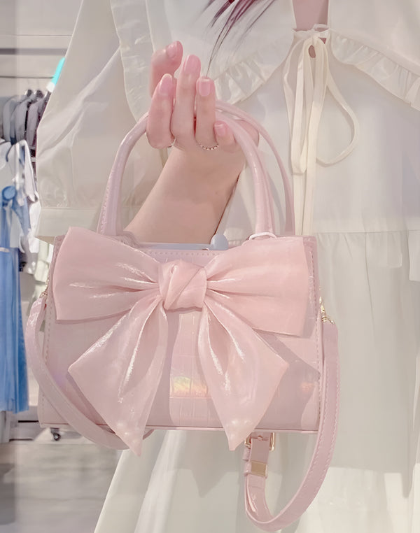 Model holding Pink Kawaii Bow Handbag to showcase Harajuku fashion style.