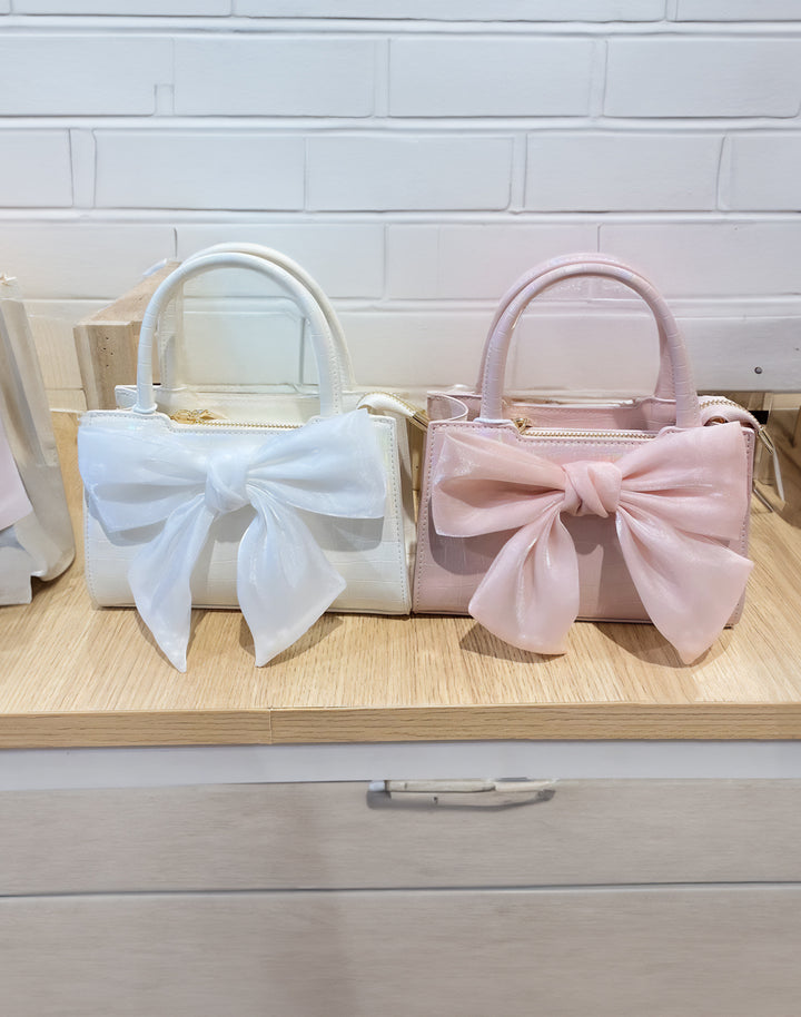 White and Pink Kawaii Bow Handbags side by side, showcasing variety in Japanese Kawaii Style.