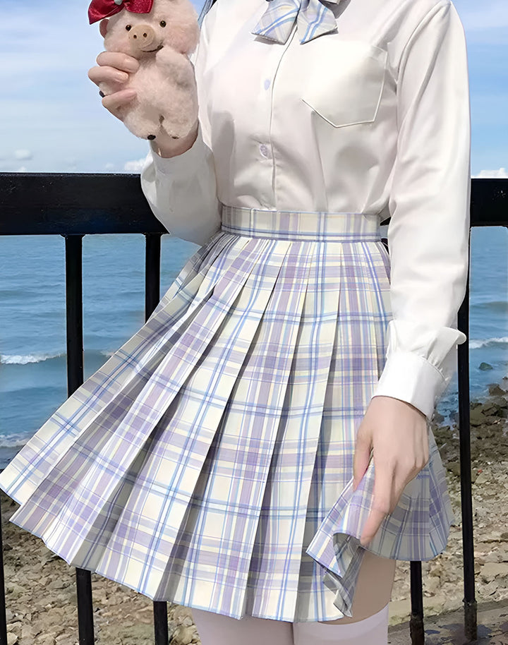 model wearing plaid skirt with sea backgroud