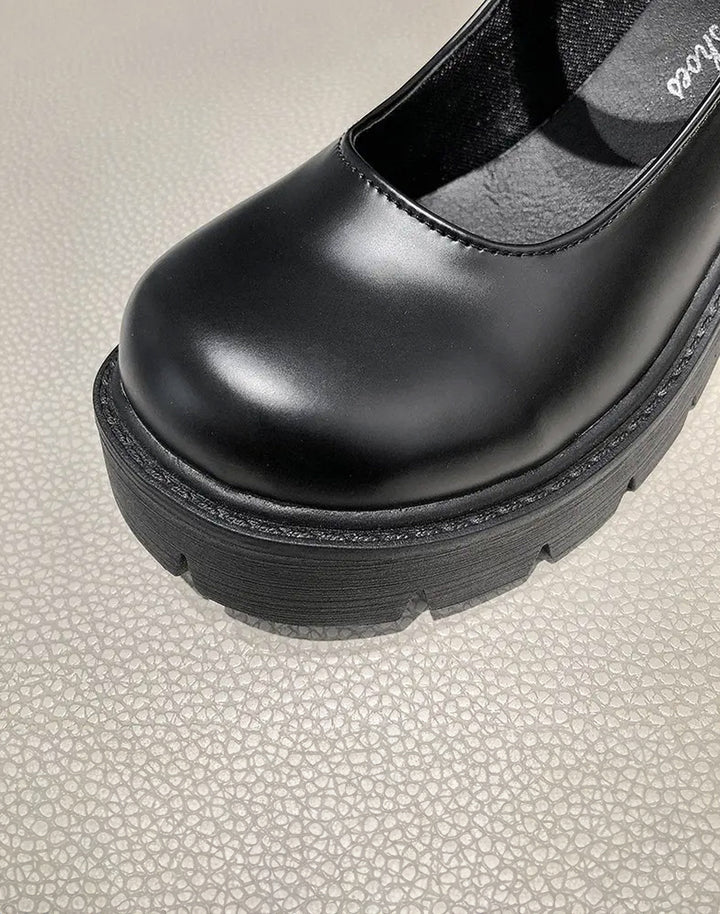The front view of matte finish black platform shoes for women
