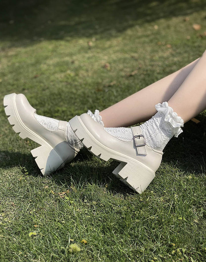 Model styling european platform shoes in white color with kawaii socks