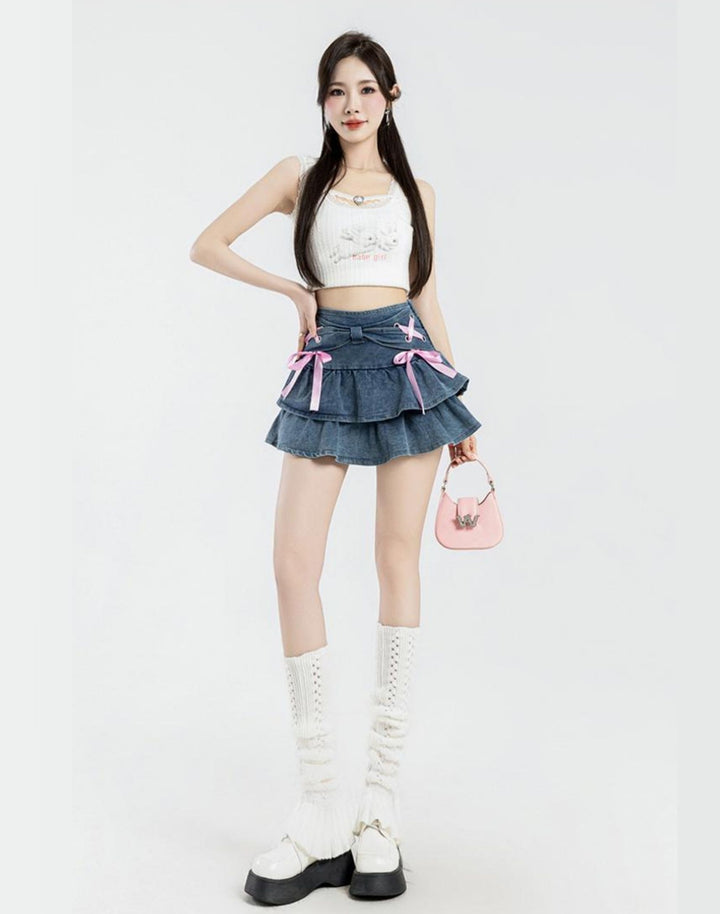 Full body shot of a model wearing the kawaii Mini Denim Ruffle Skirt paired with a white crop top, creating a Y2K inspired look.