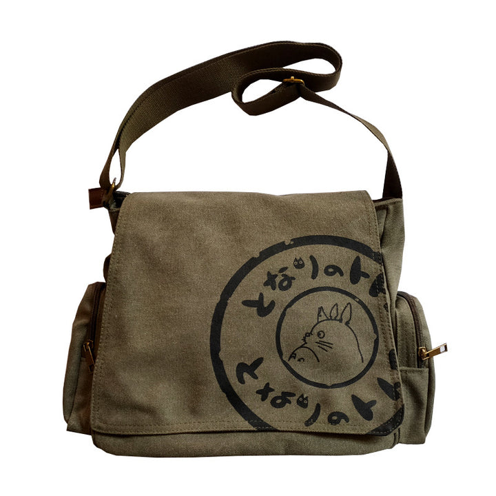 Green Totoro messenger bag with black Totoro graphic and Japanese text on the front flap.