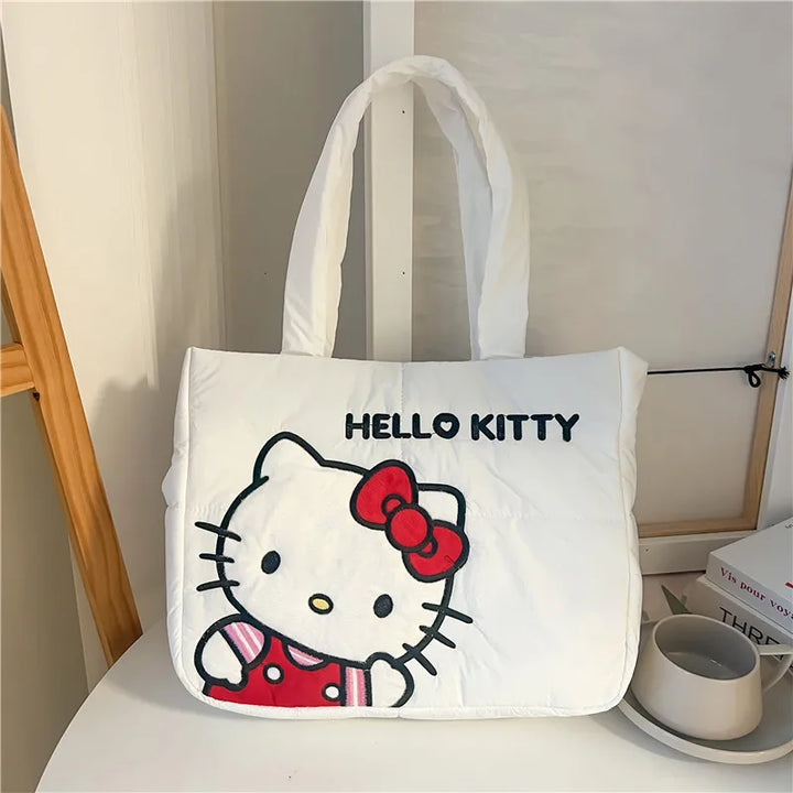 Hello Kitty puffer bag displayed on a table, showcasing its spacious design. Shop cute handbags for school at Street Kawaii