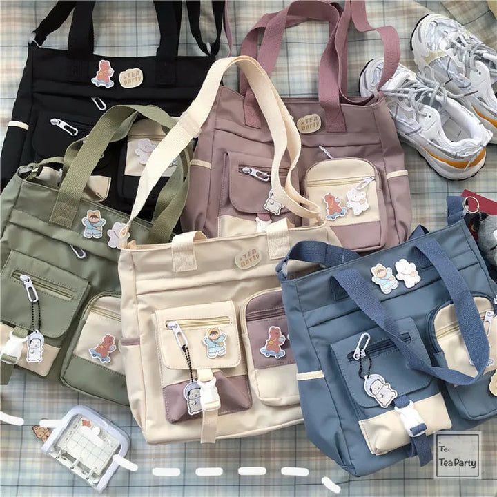 All color variations of the Kawaii Multi-Pocket Nylon Shoulder Bag laid out, including black, green, beige, pink, and blue, highlighting their multiple pockets and cute accessories.