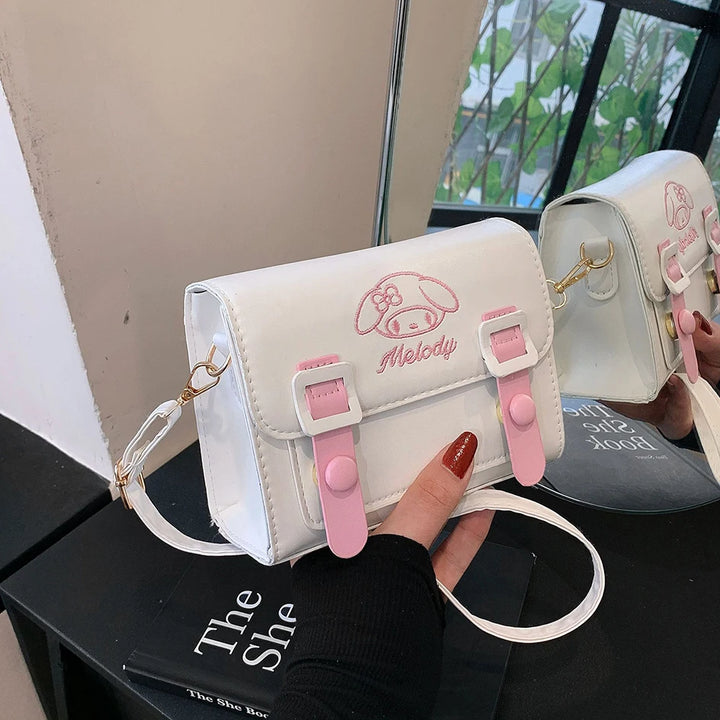 Front view of the My Melody messenger bag with a white base, pink buckle straps, and My Melody design, ideal for kawaii aesthetic and Sanrio fans.