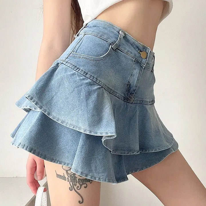 Side view of a light blue denim mini skirt with soft ruffles and subtle frayed hem, showcasing the A-line silhouette and flattering high-waist design.