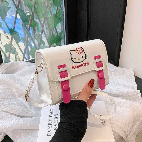 Front view of the Hello Kitty messenger bag featuring a white base with pink buckle straps and Hello Kitty design, perfect for kawaii and Sanrio fashion.