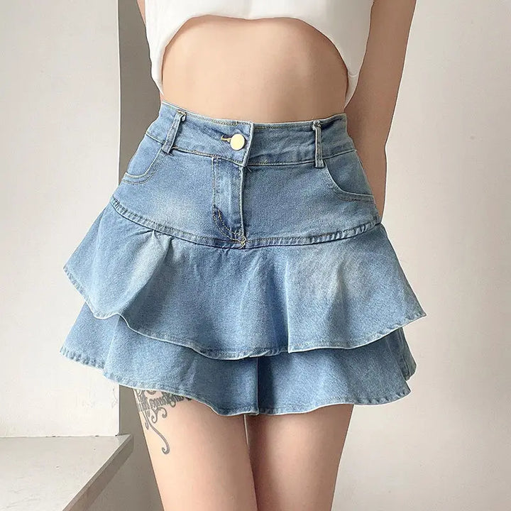 Front view of a light blue denim mini skirt with soft ruffles and subtle frayed hem, showcasing the A-line silhouette and flattering high-waist design.