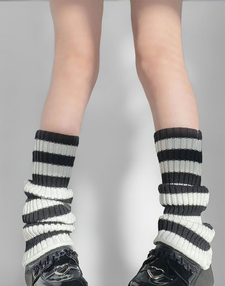 Fashionable black and white striped leg warmers displayed, capturing the essence of Y2K style.
