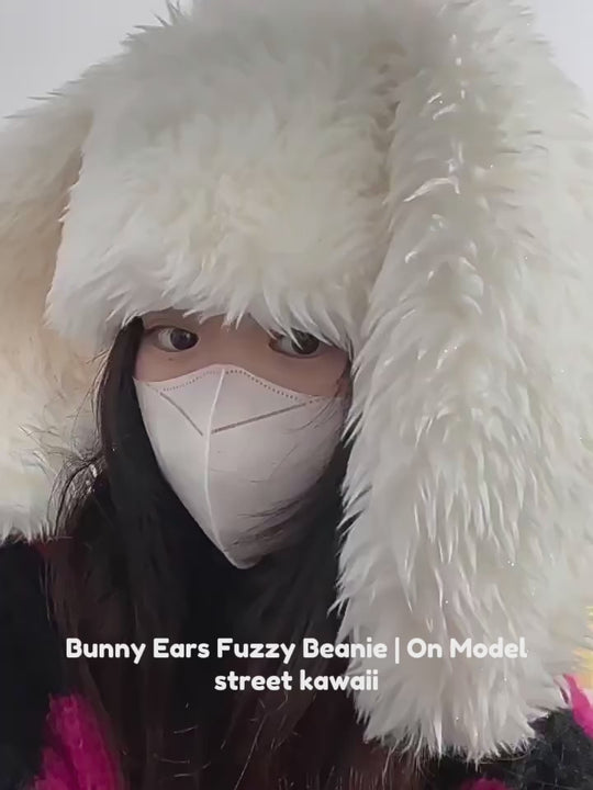 Close-up video of a model wearing a fuzzy beanie with bunny ears, showing detailed texture and fit.