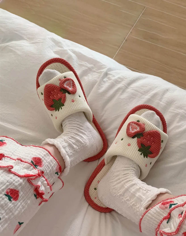feet wearing strawberry sandals